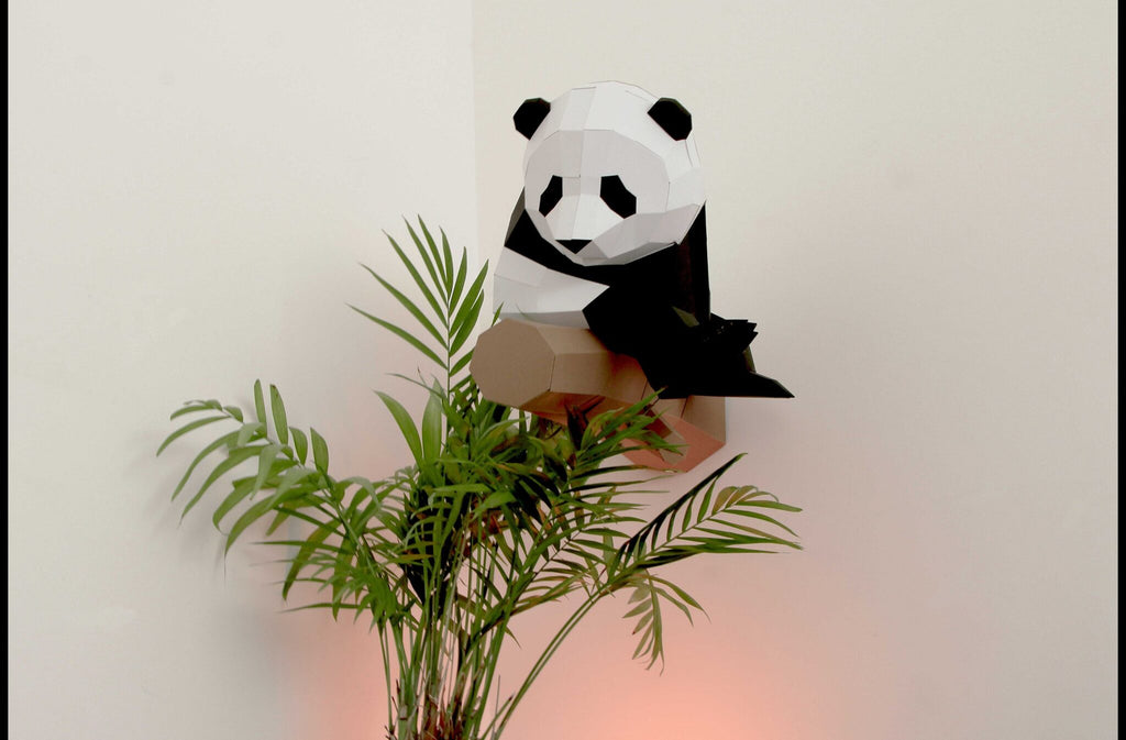 Little 3D paper panda on a branch