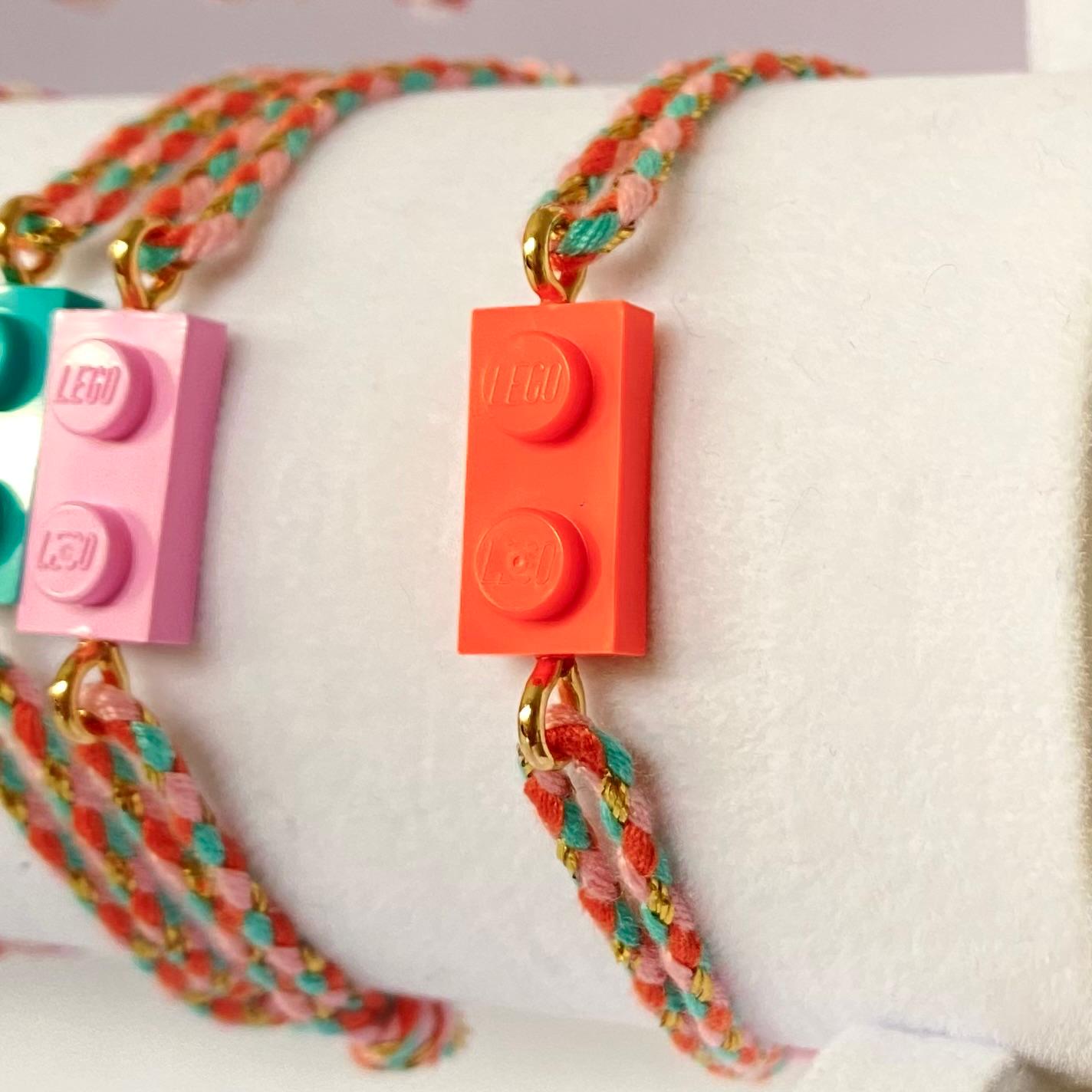 Adjustable braided coral-green cord bracelet with matching Lego brick