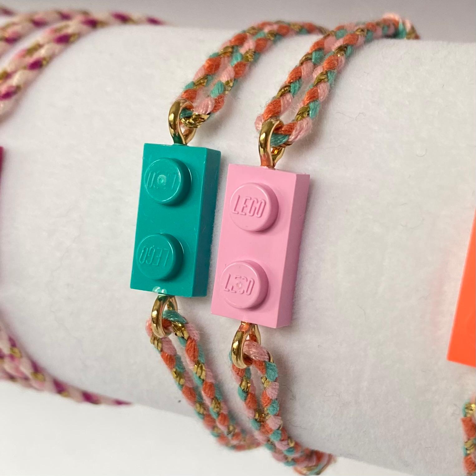 Adjustable braided coral-green cord bracelet with matching Lego brick