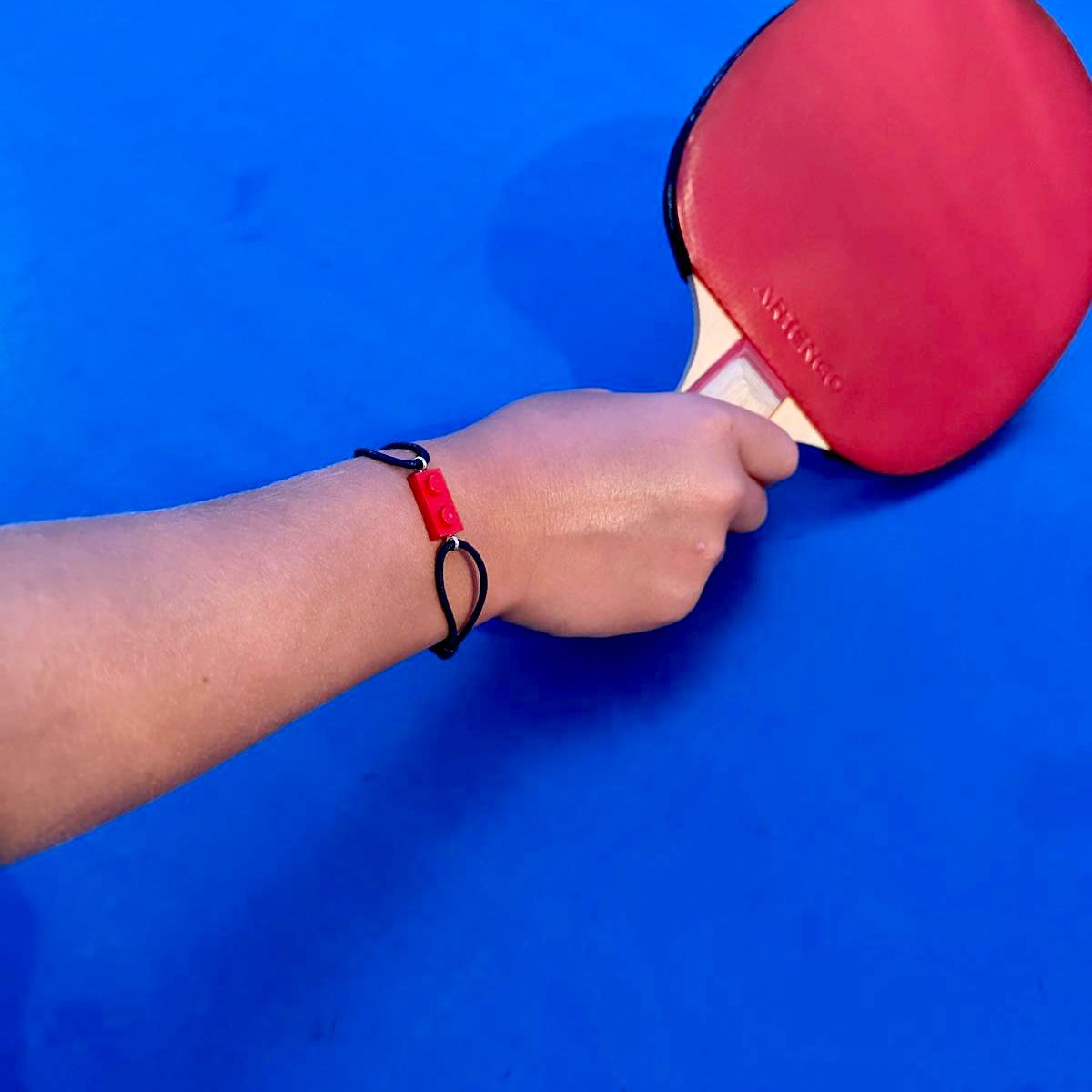 Friendship bracelet with a Lego brick and adjustable cotton cord