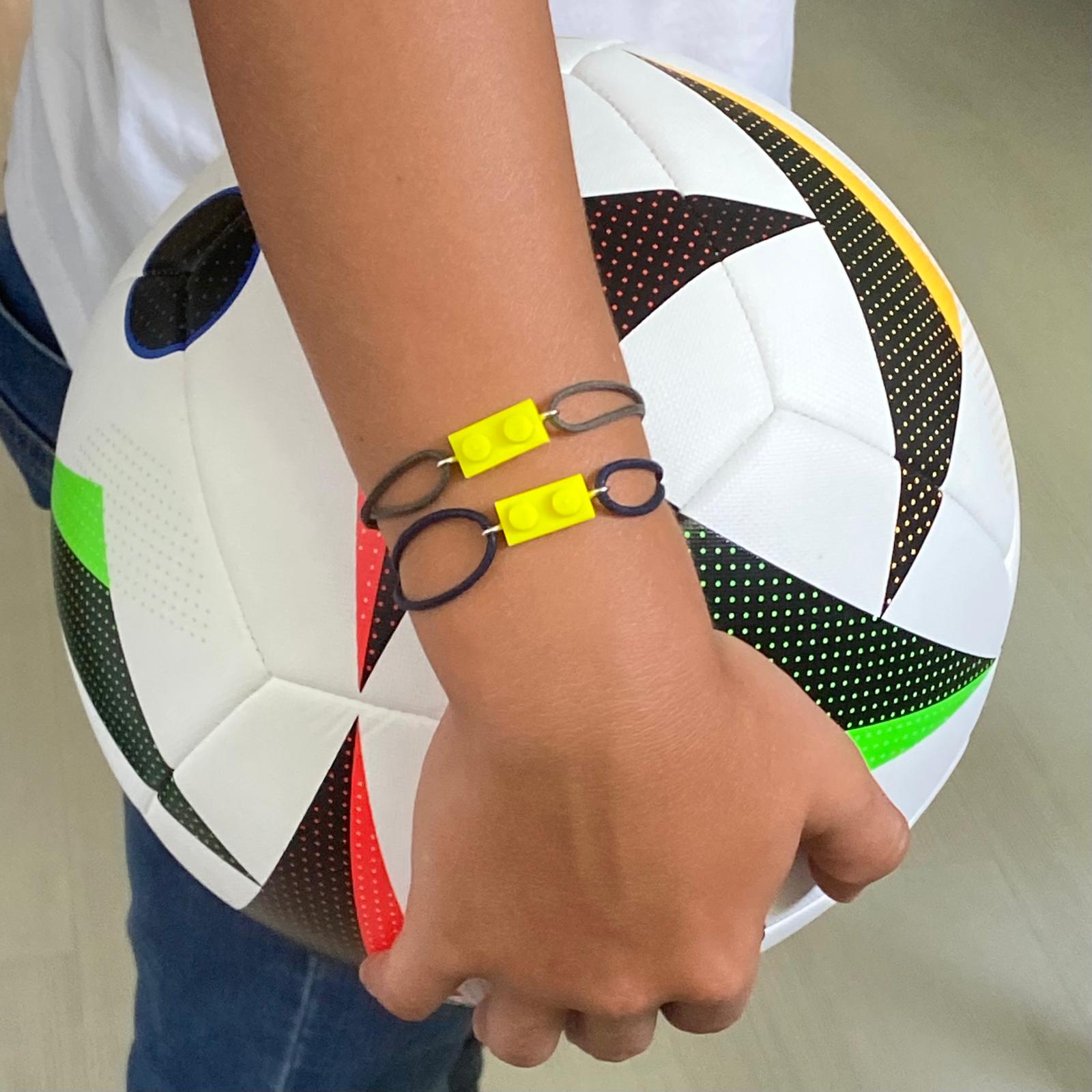Fluorescent bracelet with a Lego® and an adjustable cord