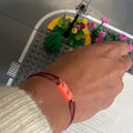 Fluorescent bracelet with a Lego® and an adjustable cord