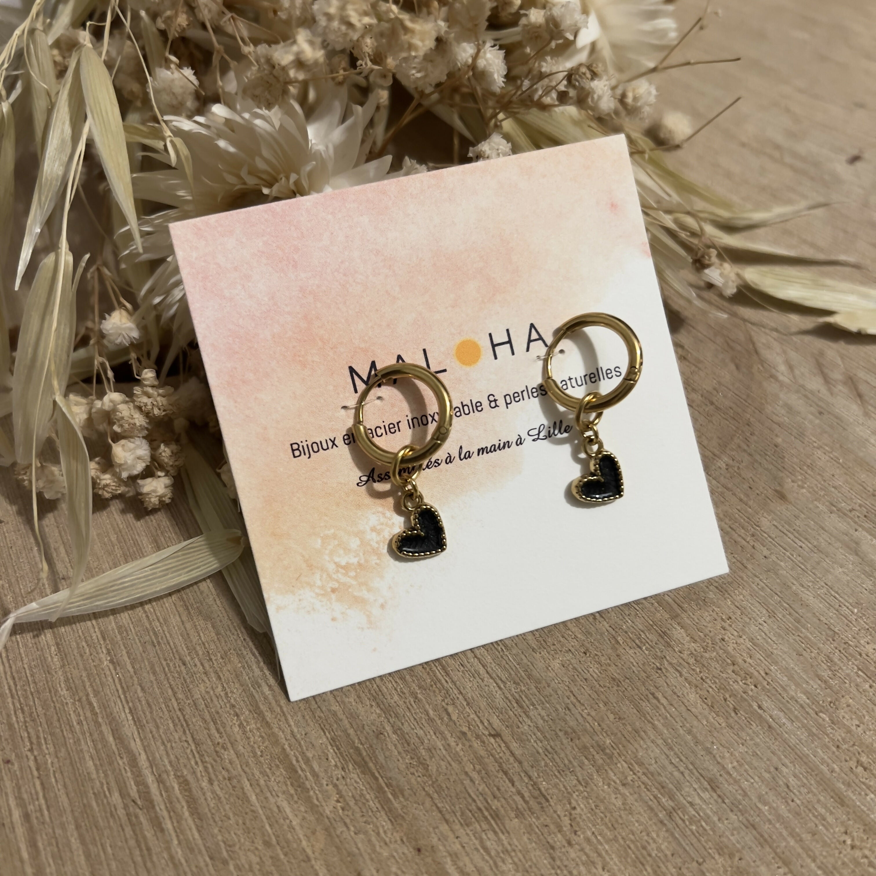 Hoop earrings & their small black hearts
